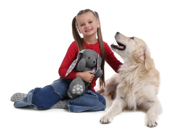 Photo of Girl with toy bunny and her cute Golden Retriever dog on white background