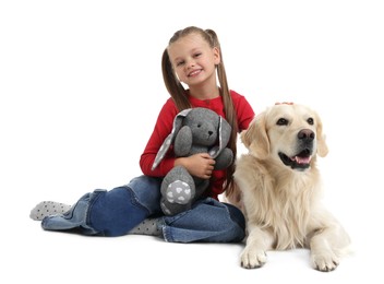 Girl with toy bunny and her cute Golden Retriever dog on white background