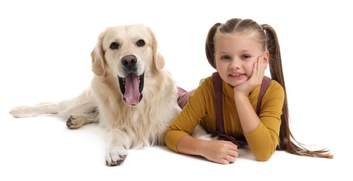 Girl with her cute Golden Retriever dog lying on white background