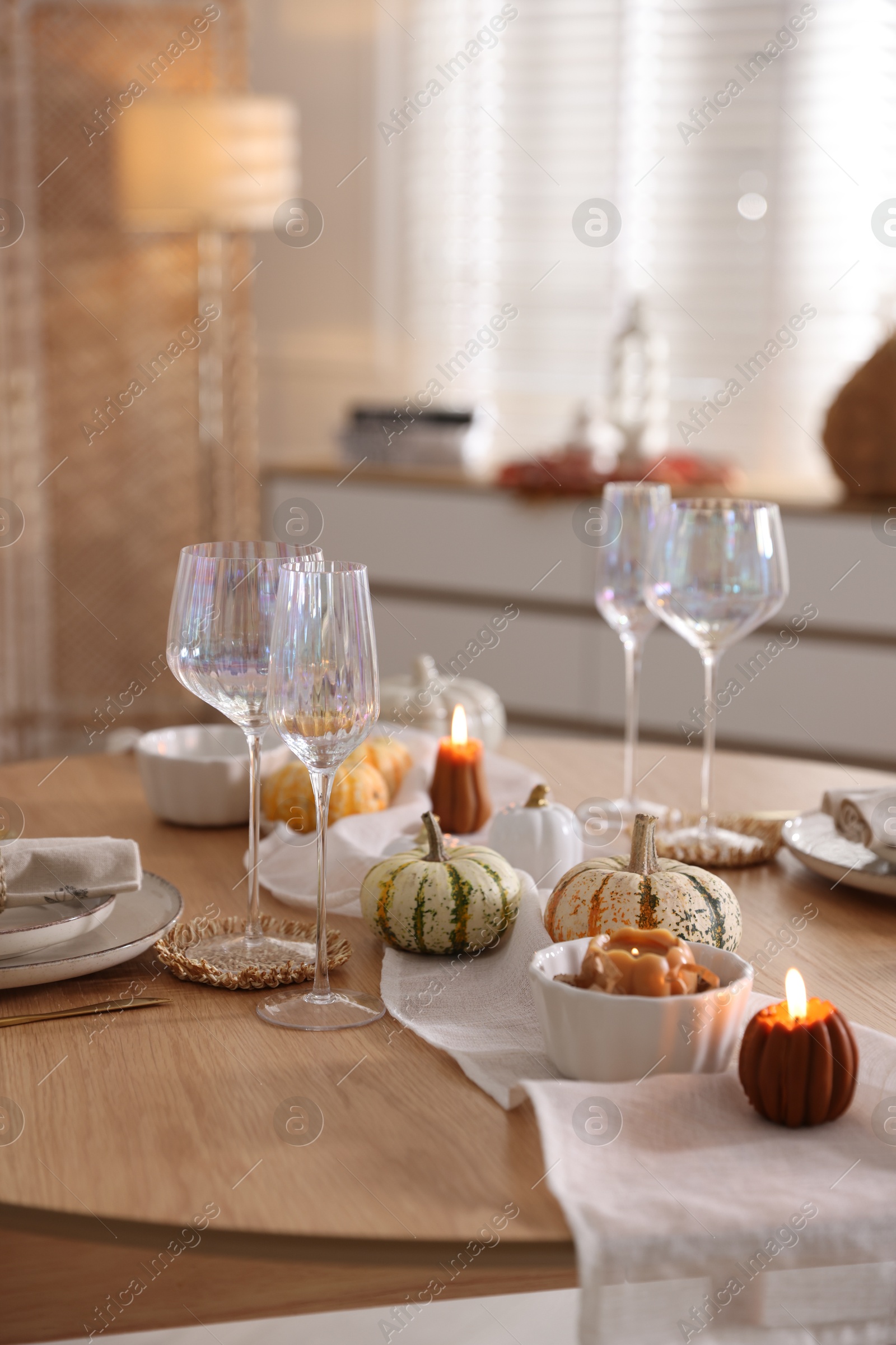 Photo of Stylish table setting with beautiful dishware and autumn decor in dining room