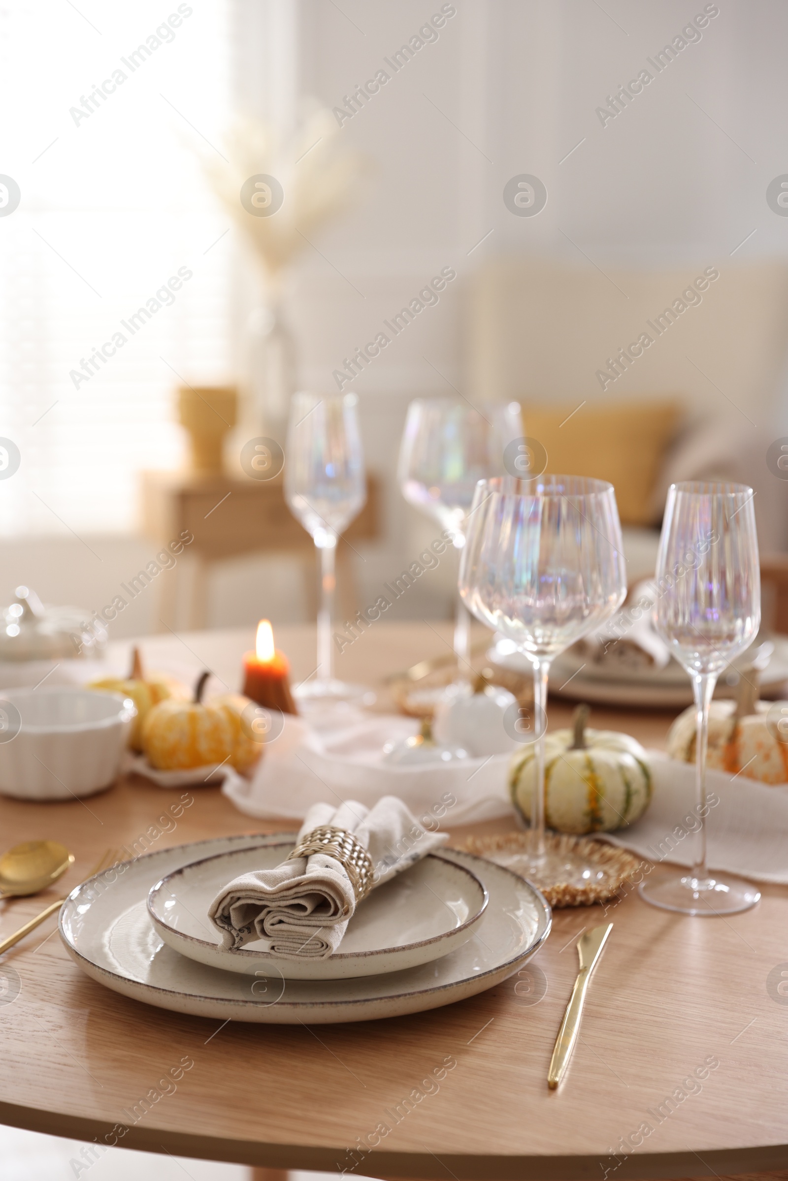 Photo of Stylish table setting with beautiful dishware and autumn decor in dining room