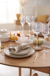 Photo of Stylish table setting with beautiful dishware and autumn decor in dining room