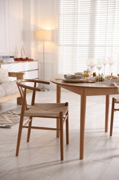 Photo of Stylish table setting with beautiful dishware and autumn decor in dining room