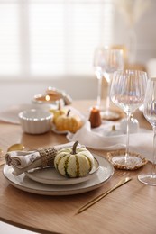 Photo of Stylish table setting with beautiful dishware and autumn decor in dining room