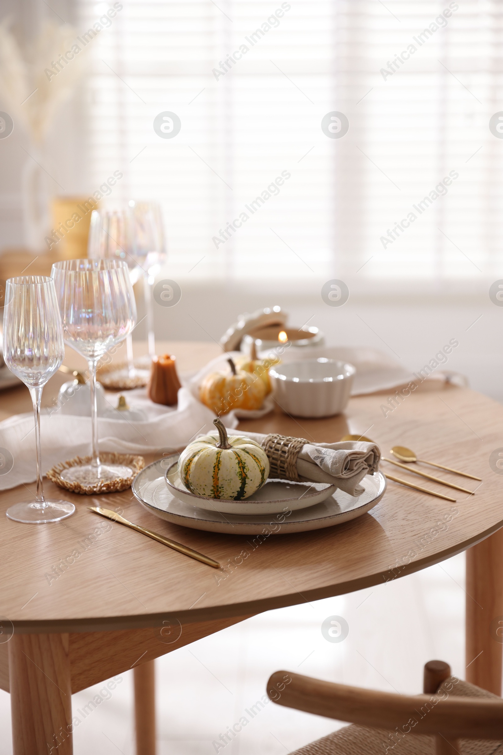 Photo of Stylish table setting with beautiful dishware and autumn decor in dining room