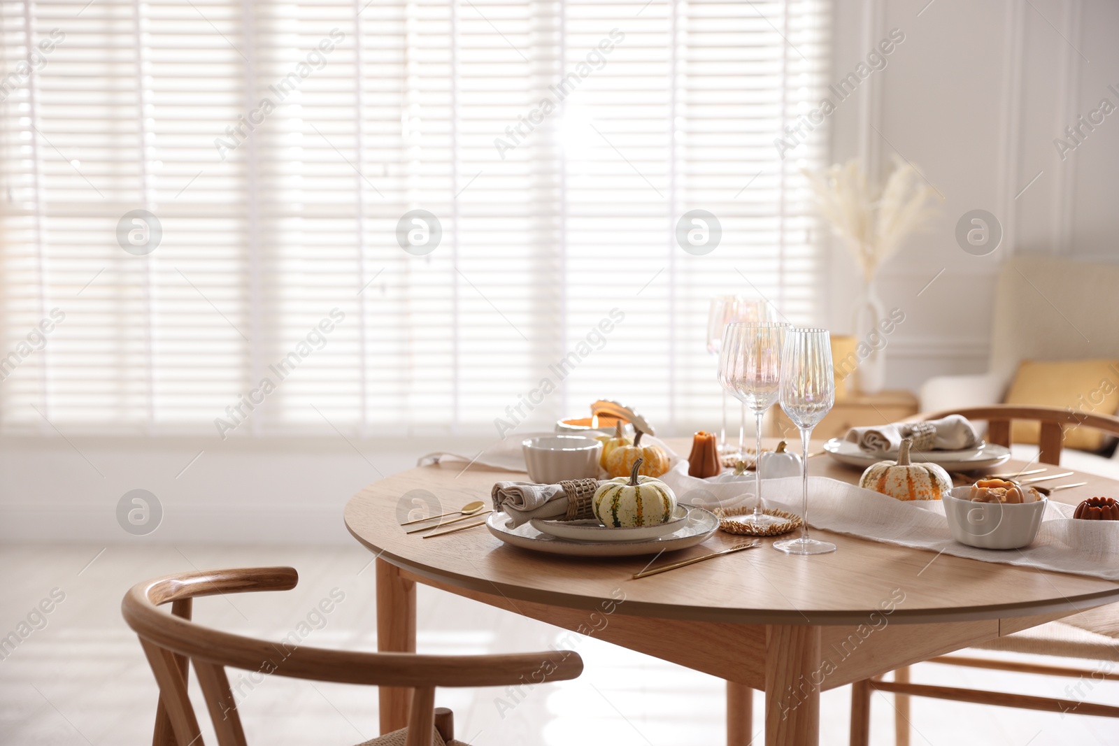 Photo of Stylish table setting with beautiful dishware and autumn decor in dining room