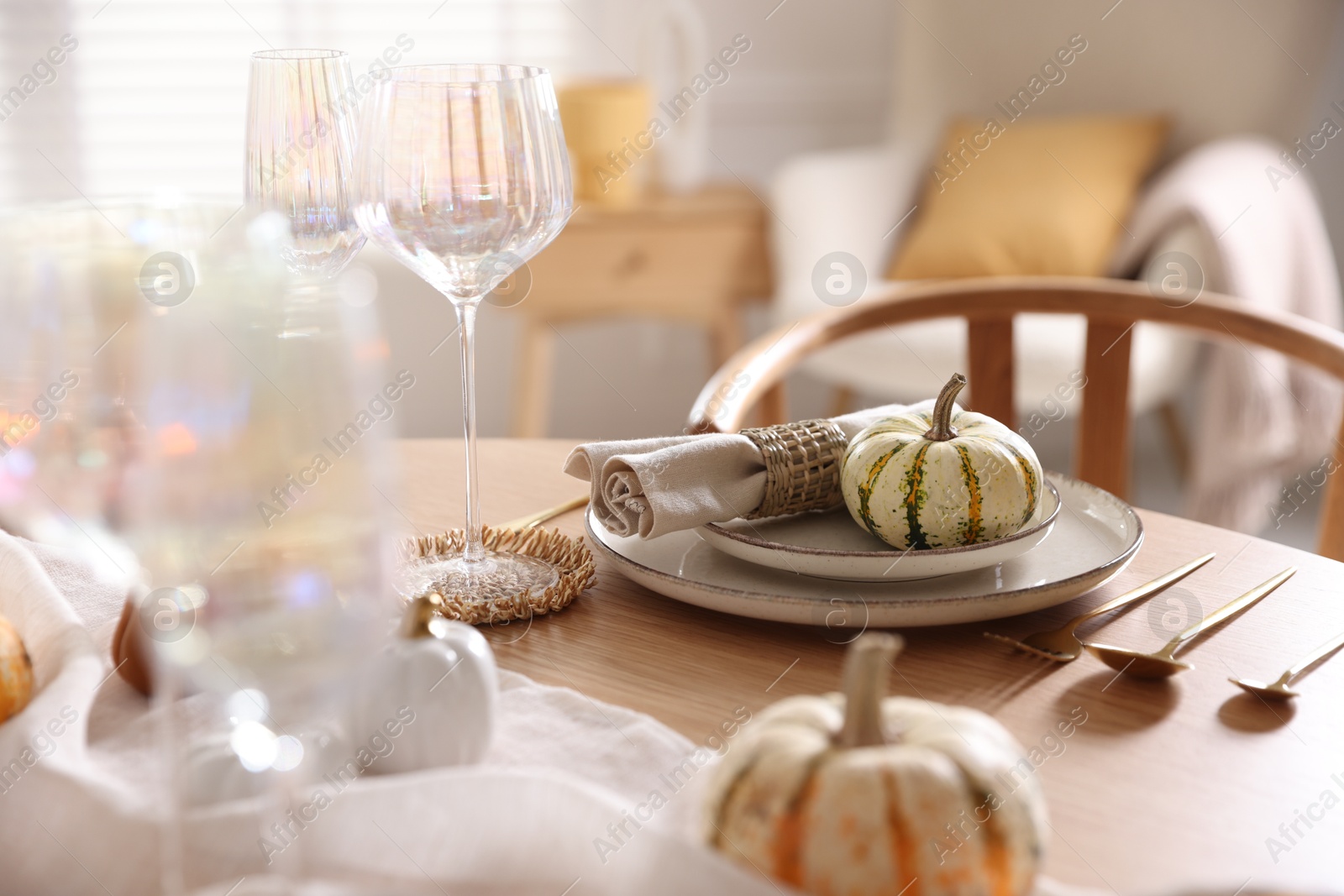 Photo of Stylish table setting with beautiful dishware and autumn decor in dining room, closeup