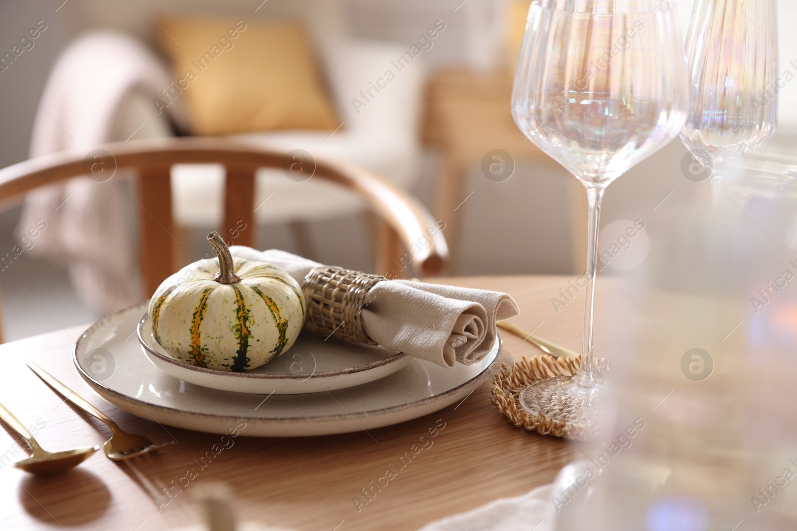 Photo of Stylish table setting with beautiful dishware and autumn decor in dining room, closeup