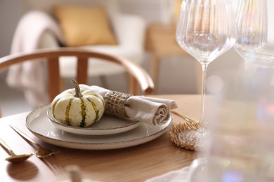 Stylish table setting with beautiful dishware and autumn decor in dining room, closeup