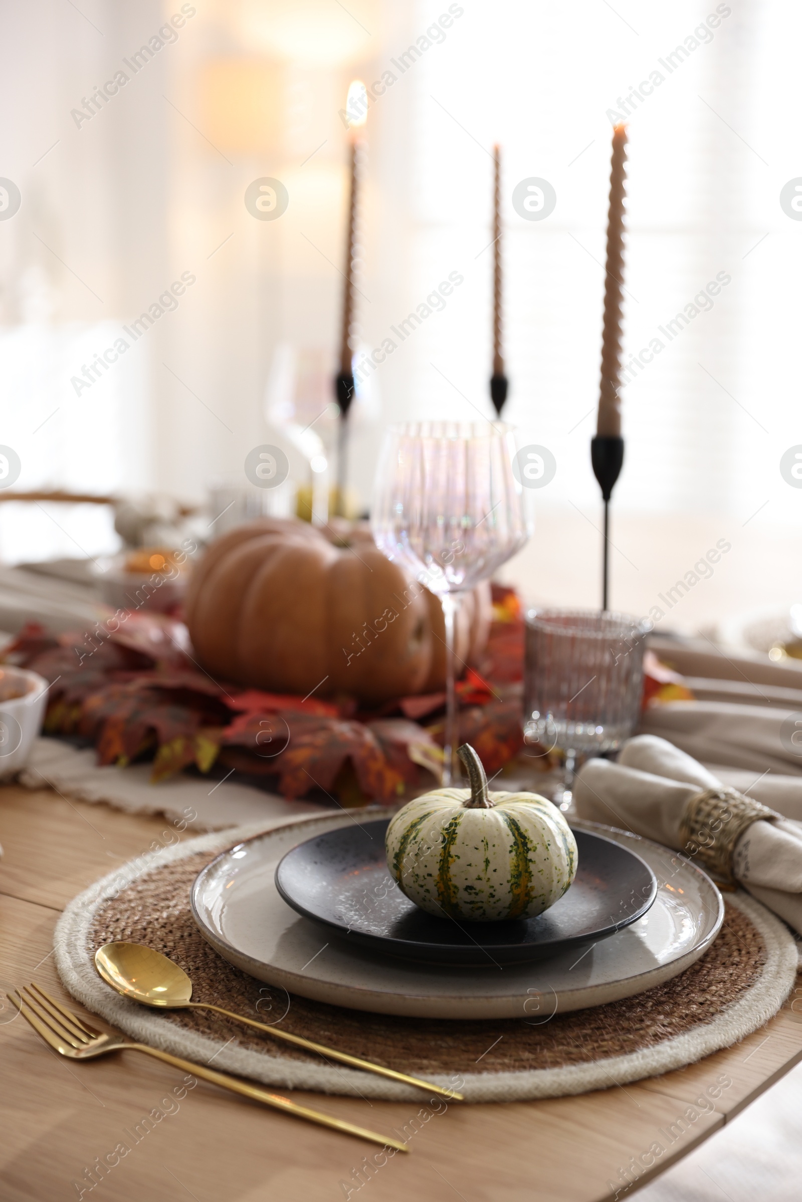 Photo of Stylish table setting with beautiful dishware and autumn decor in dining room