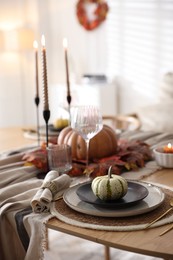 Photo of Stylish table setting with beautiful dishware and autumn decor in dining room