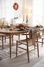 Photo of Stylish table setting with beautiful dishware and autumn decor in dining room