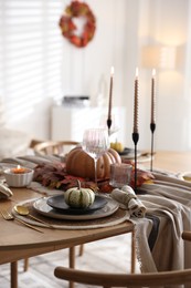 Photo of Stylish table setting with beautiful dishware and autumn decor in dining room