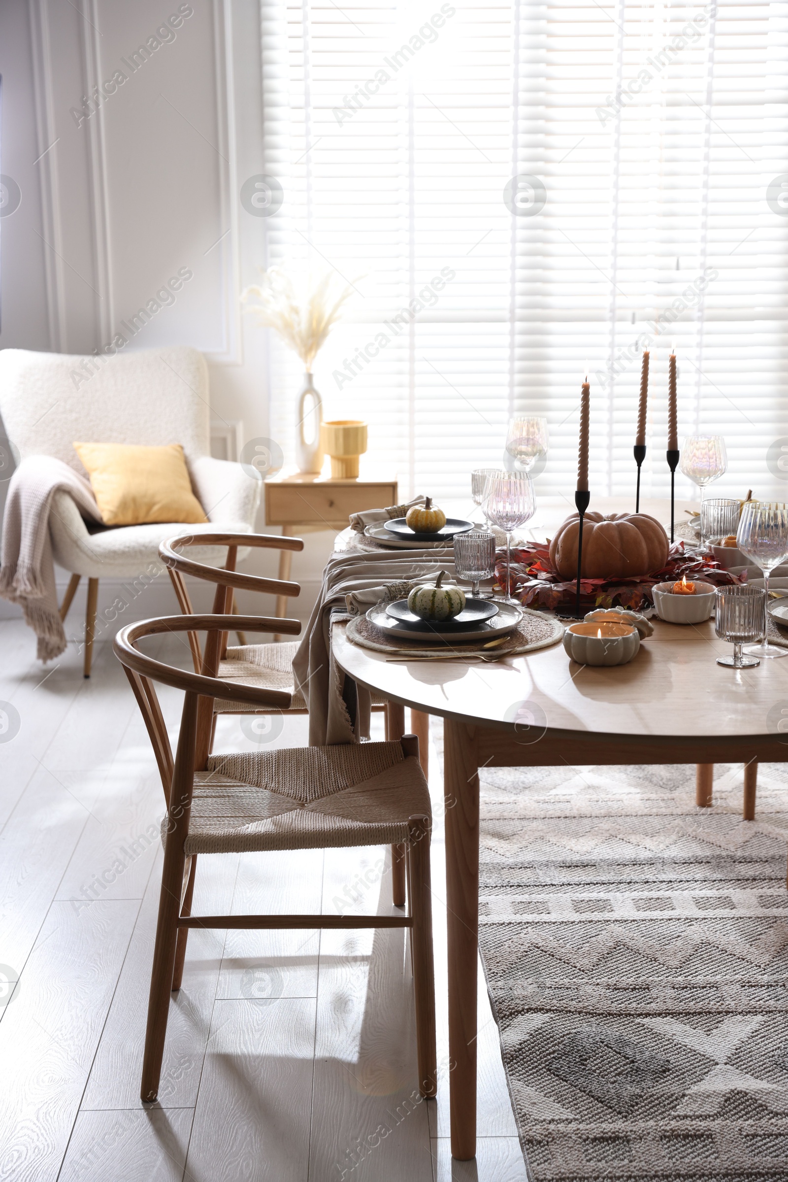 Photo of Stylish table setting with beautiful dishware and autumn decor in dining room