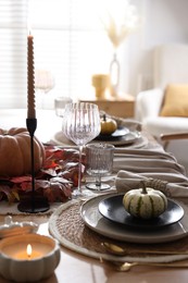 Photo of Stylish table setting with beautiful dishware and autumn decor in dining room