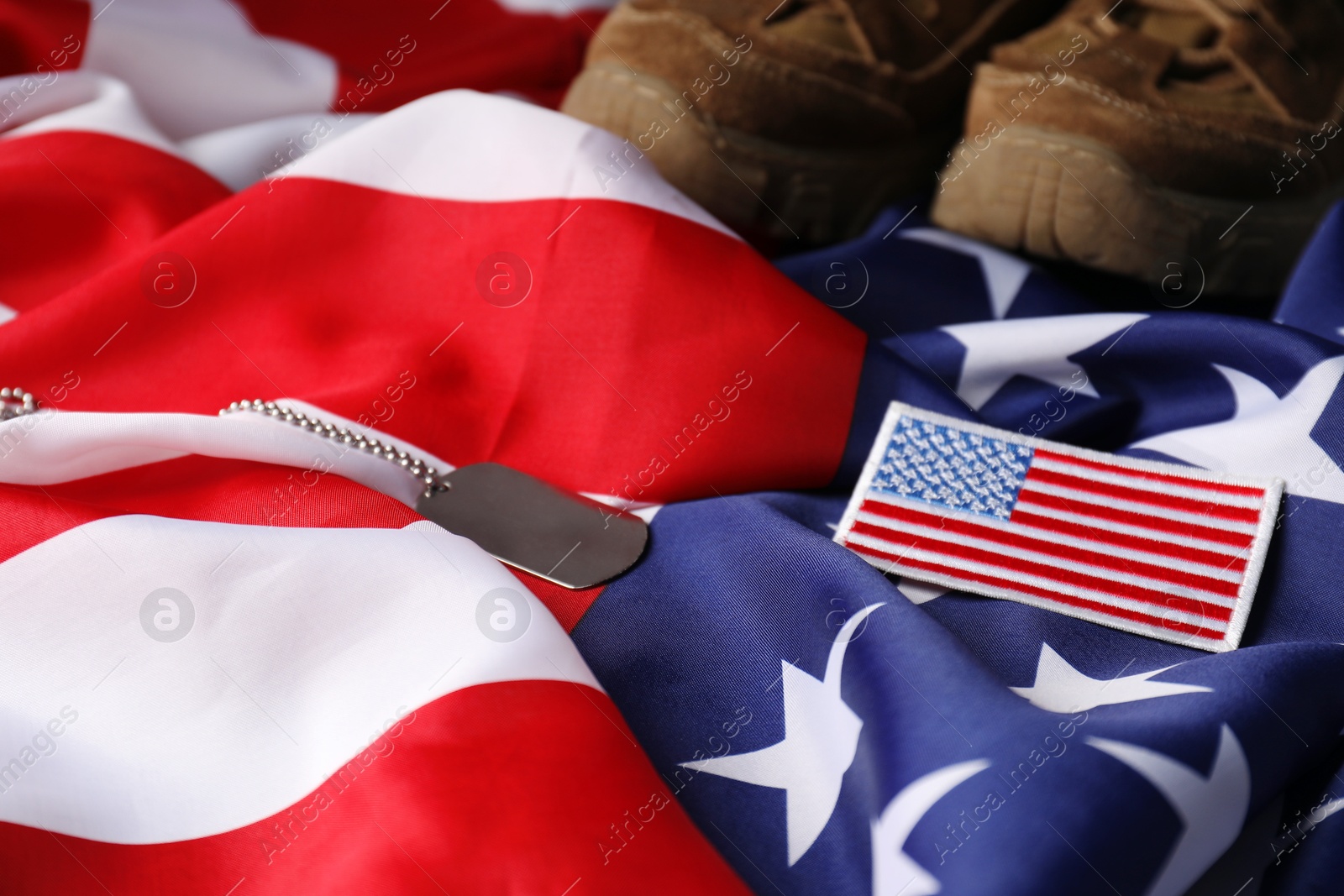 Photo of Veterans day. USA army patch, American flag and military shoes, closeup