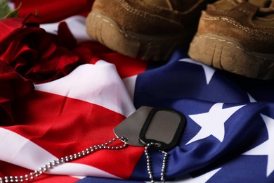 Photo of Veterans day. American flag, roses and army tokens, closeup