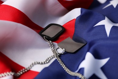 Photo of Veterans day. Army tokens and American flag, closeup