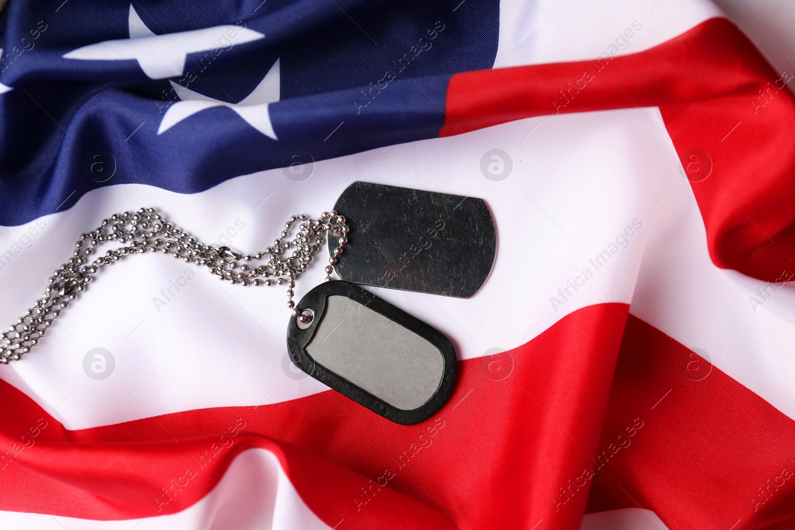 Photo of Veterans day. Army tokens and American flag, top view