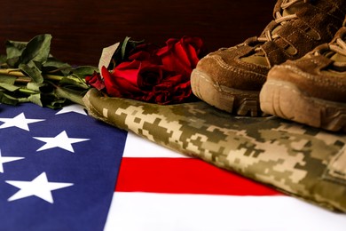 Photo of Veterans day. American flag, roses and military uniform, closeup