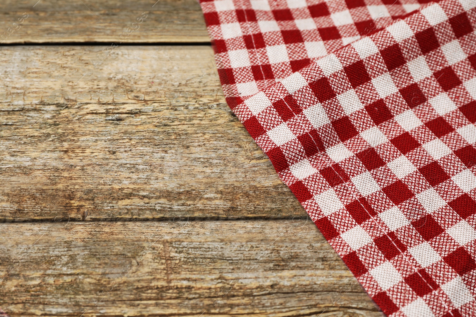 Photo of Tablecloth with checkered pattern on wooden table, space for text