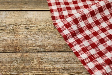 Tablecloth with checkered pattern on wooden table, space for text