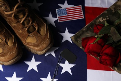 Veterans day. USA army patch, token, American flag, roses and military uniform, flat lay