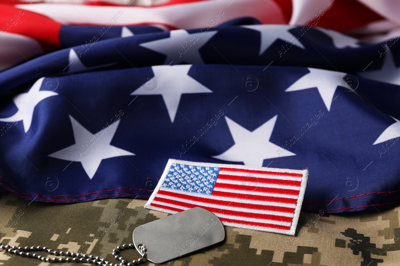 Photo of Veterans day. USA army patch, token, American flag and military uniform, closeup