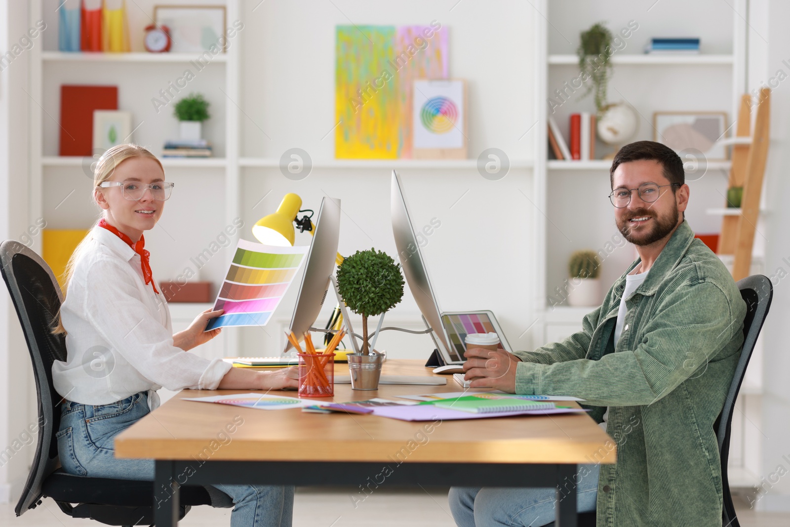 Photo of Designers working together at table in office