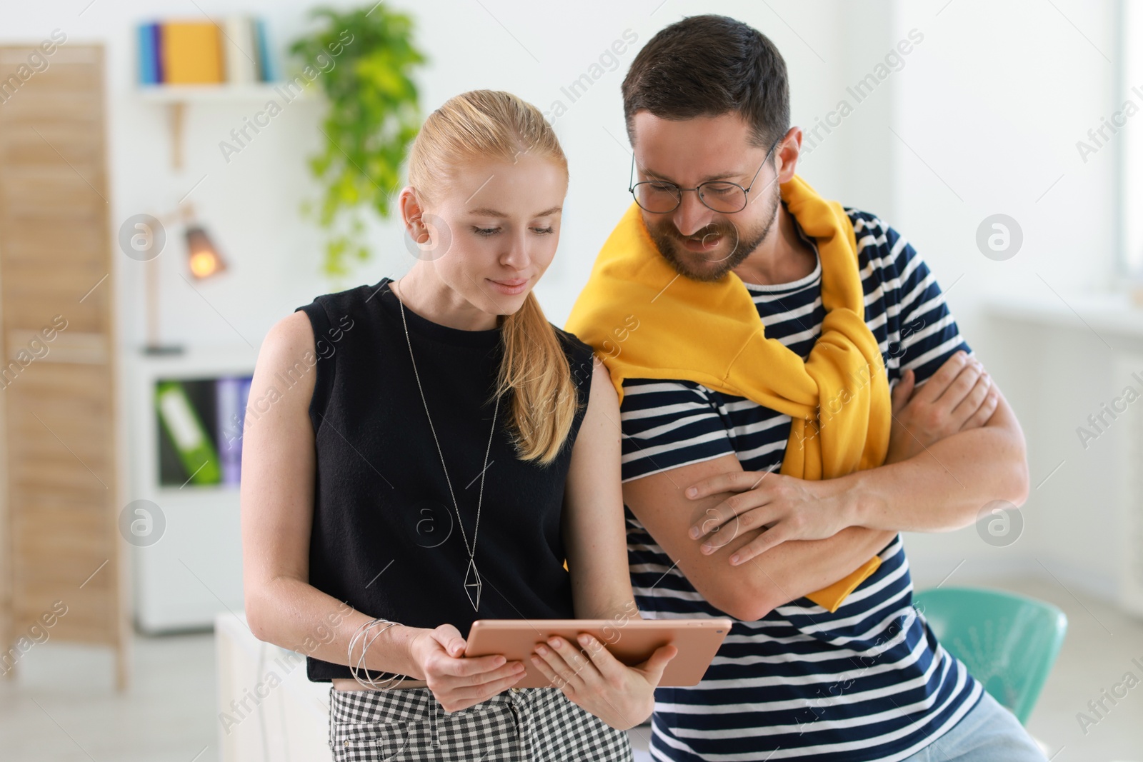 Photo of Designers with tablet working together in office