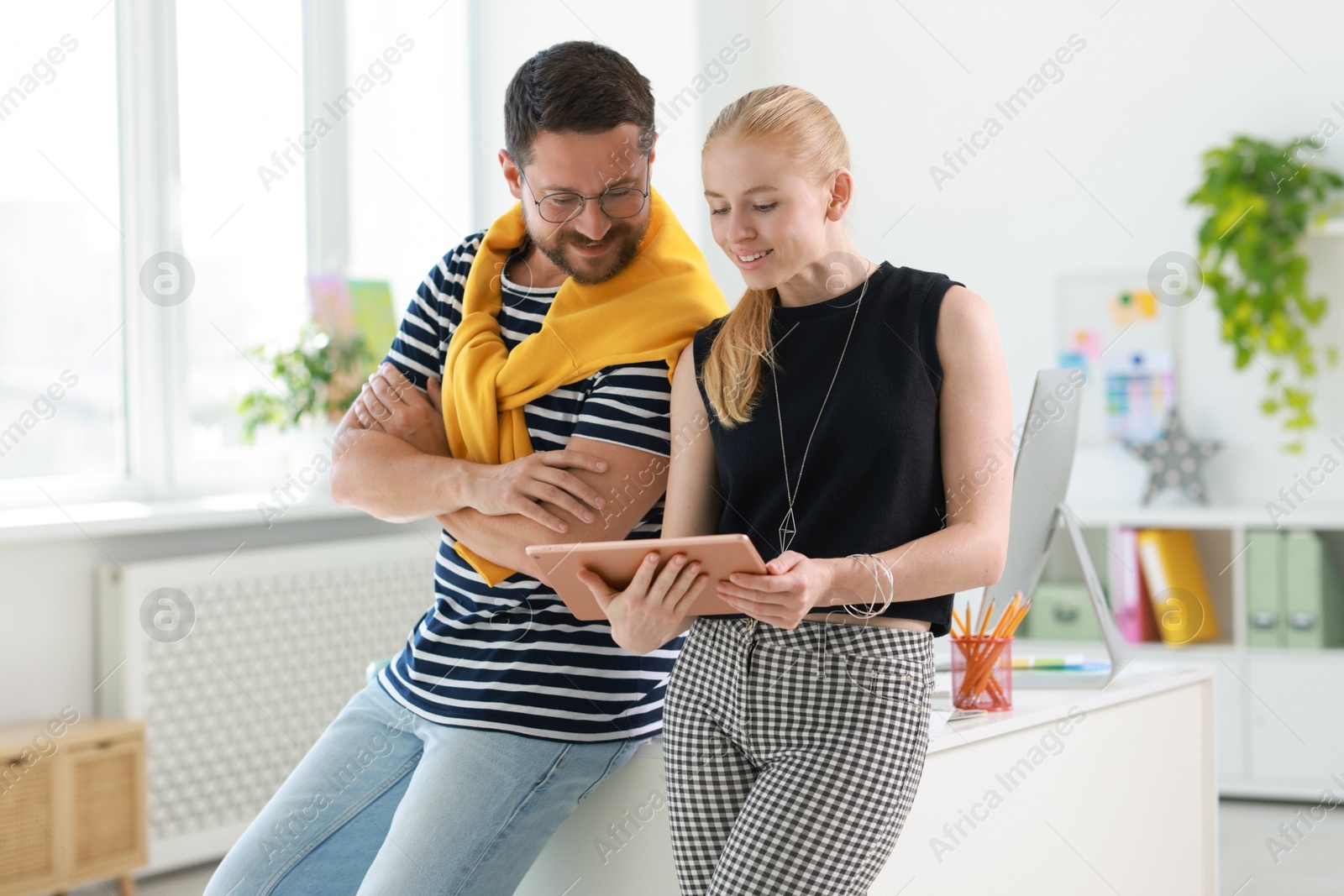 Photo of Designers with tablet working together in office