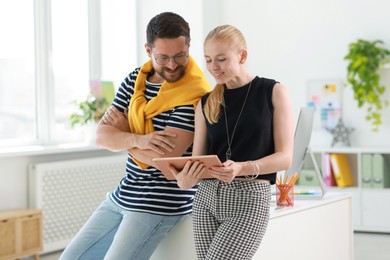 Designers with tablet working together in office