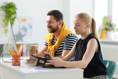 Designers working together at table in office, selective focus