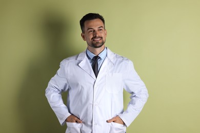 Photo of Portrait of smiling doctor on olive background