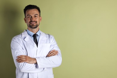 Portrait of smiling doctor on olive background, space for text