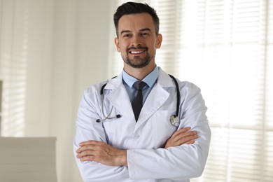 Photo of Portrait of smiling doctor with stethoscope in clinic