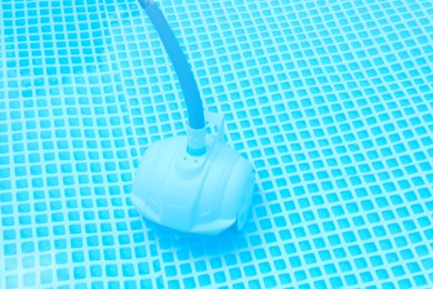 Photo of One robotic cleaner in swimming pool outdoors