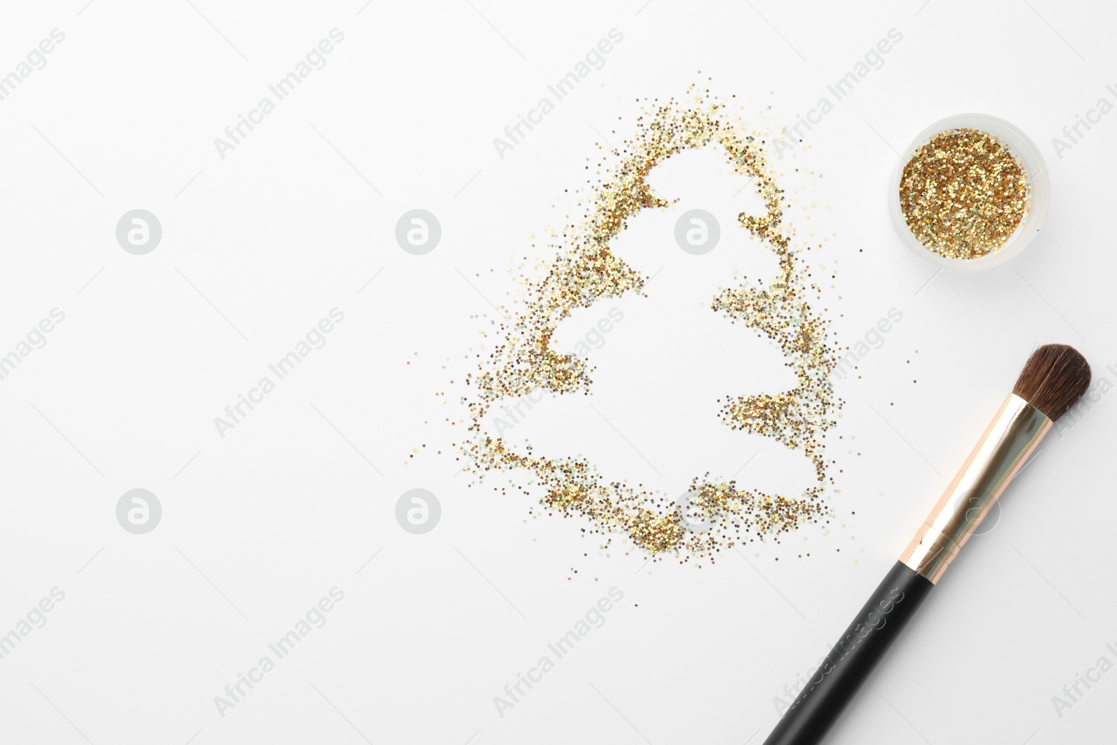 Photo of Christmas tree made of glitter and makeup brush on white background, flat lay. Space for text