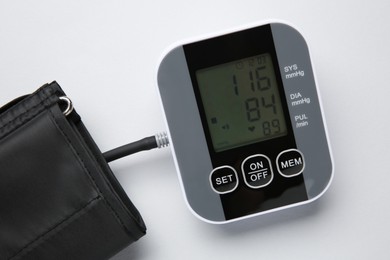 Photo of Blood pressure measuring device on white background, top view