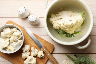 Photo of Cauliflower on white wooden table, flat lay. Washing, cutting, cooking