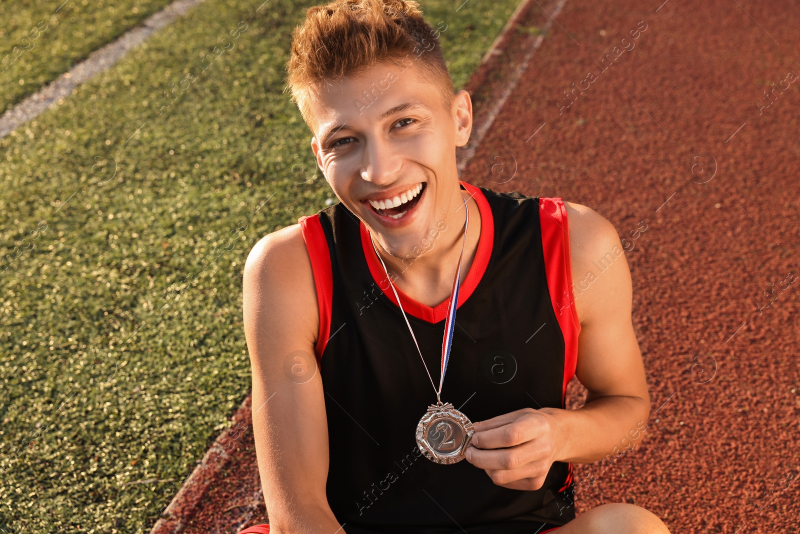 Photo of Happy winner with silver medal at stadium