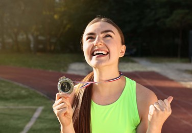 Happy winner with silver medal at stadium