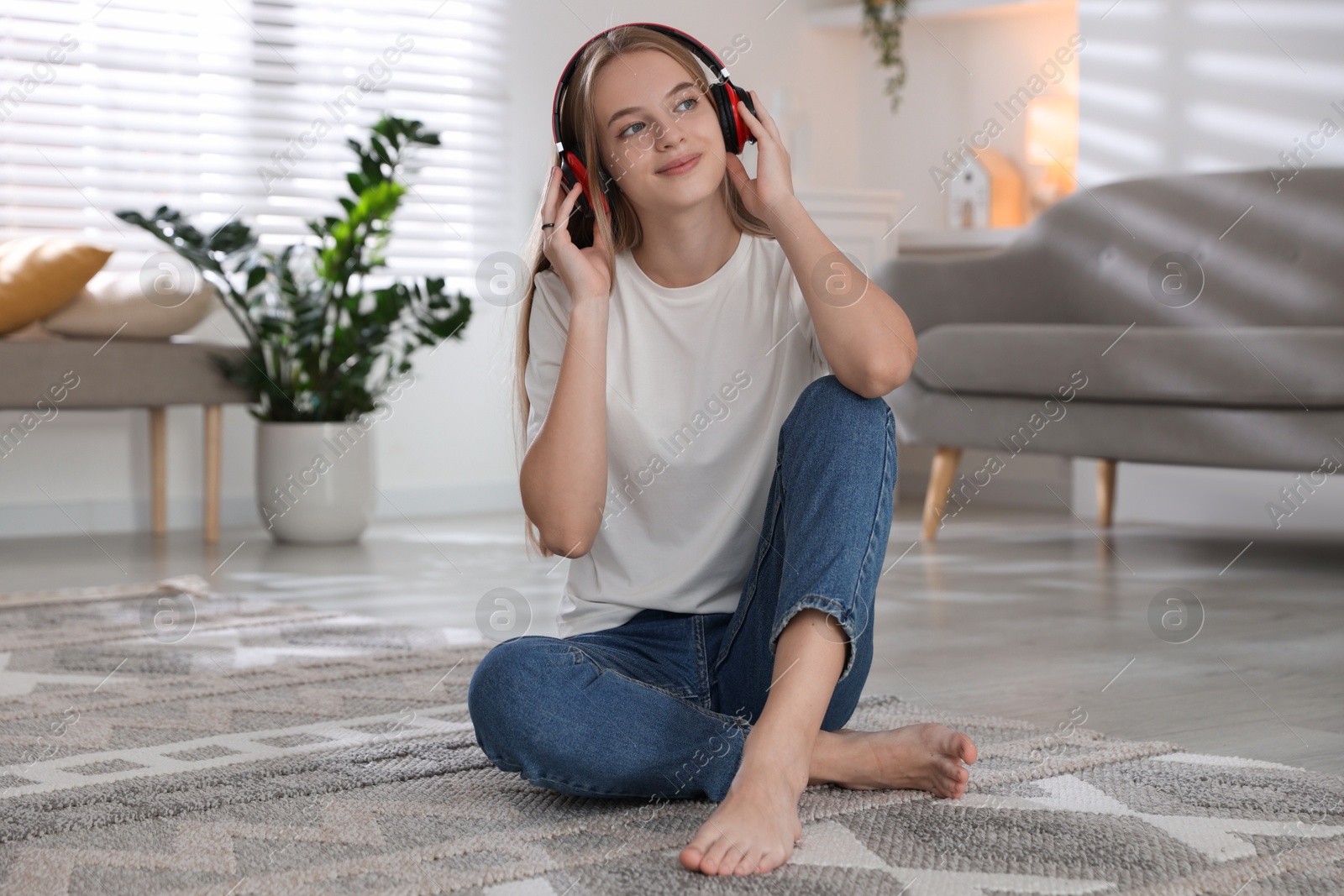 Photo of Portrait of teenage girl in headphones at home