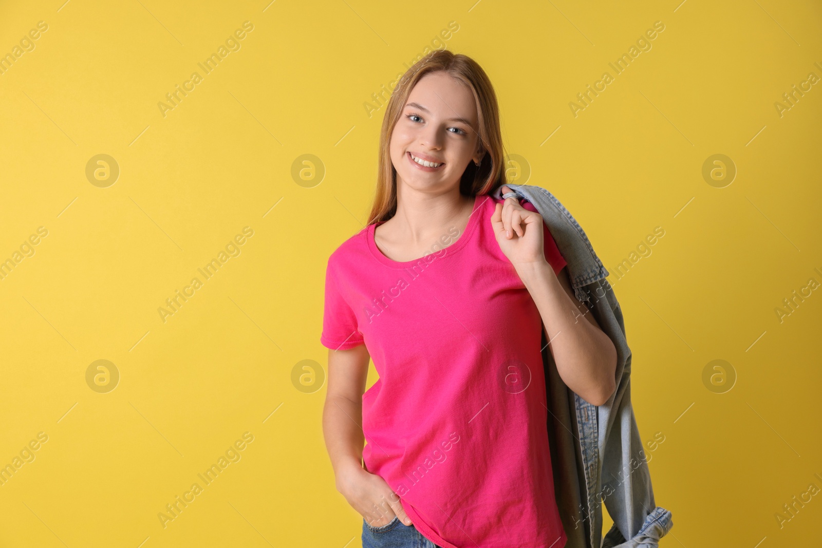 Photo of Teenage girl with denim jacket on yellow background