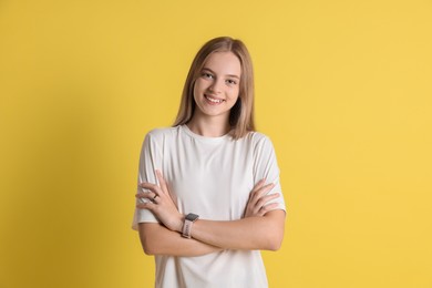 Photo of Portrait of teenage girl on yellow background