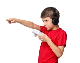 Cute little boy in headphones with controller pointing at something on white background