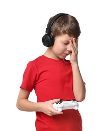 Photo of Cute little boy in headphones with controller on white background