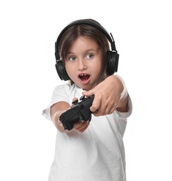 Cute little girl in headphones playing video game with controller on white background