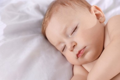 Cute little baby sleeping on bed, top view