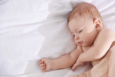 Photo of Cute little baby sleeping on bed at home, top view